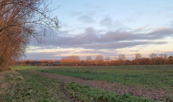 Long views north of Harwell down the vale-edge slopes to tall industrial structures in Didcot