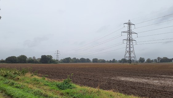 Large power pylons cross arable fields (Thame Lane)